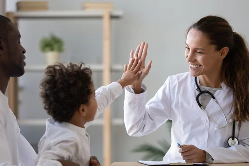 Doctor giving a child a high five